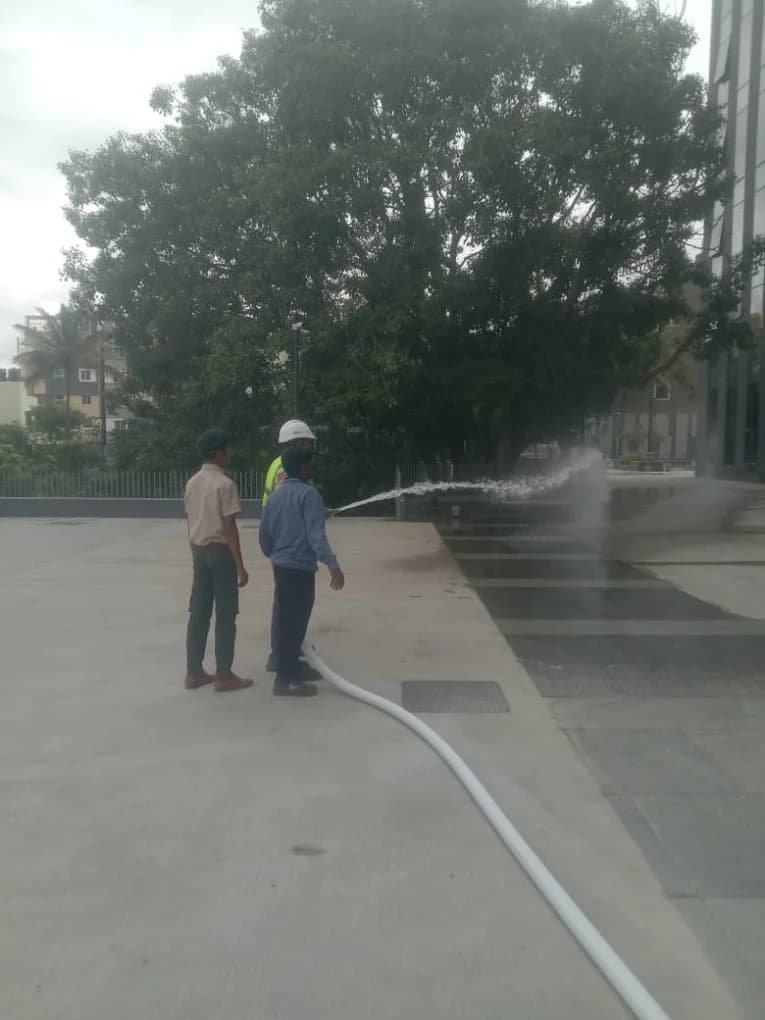 Trainees practising fire hose reel operation
